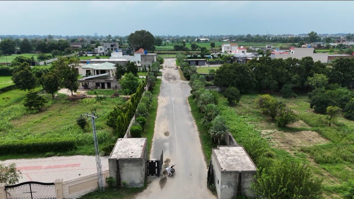 The boundary-walled community entry gate on Barki Road