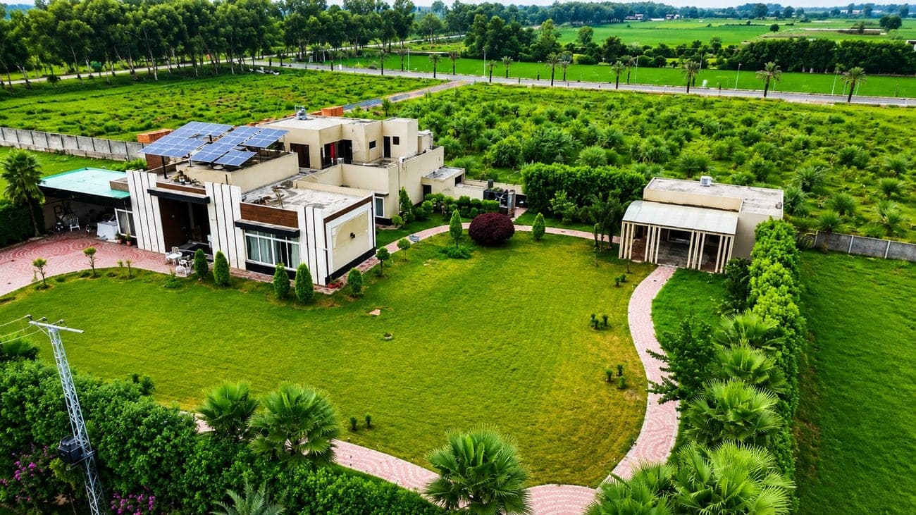 A landscaped farmhouse residence with mature planting at Flaura Farms