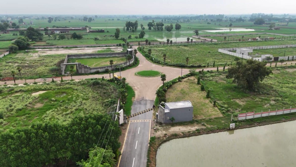 The gated community entrance with boom barrier — Nazeer Farms