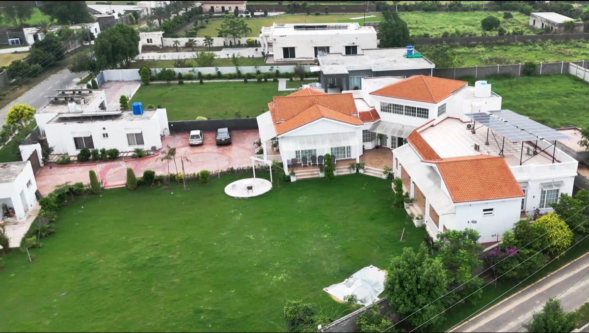 A farmhouse residence with landscaped lawn